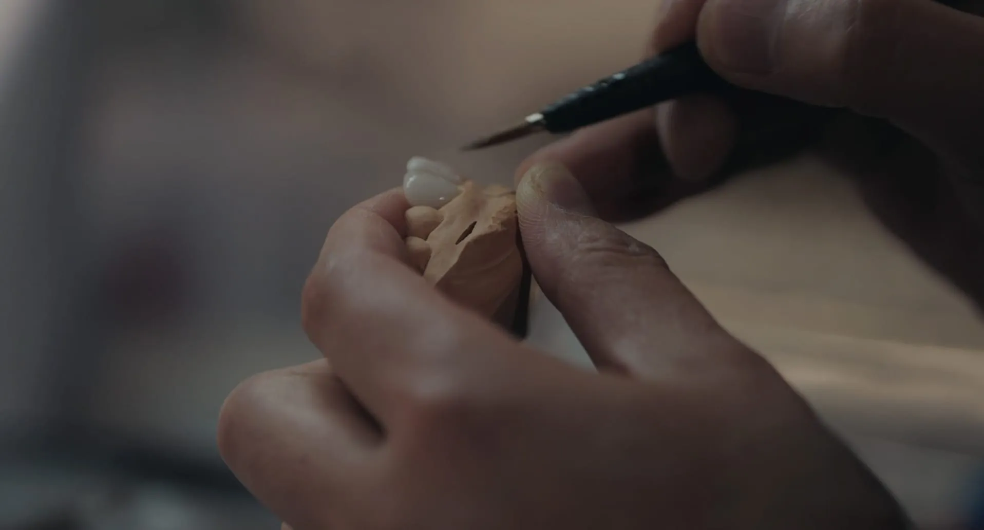 Porcelain veneer being shaped by hand in Blanche's lab